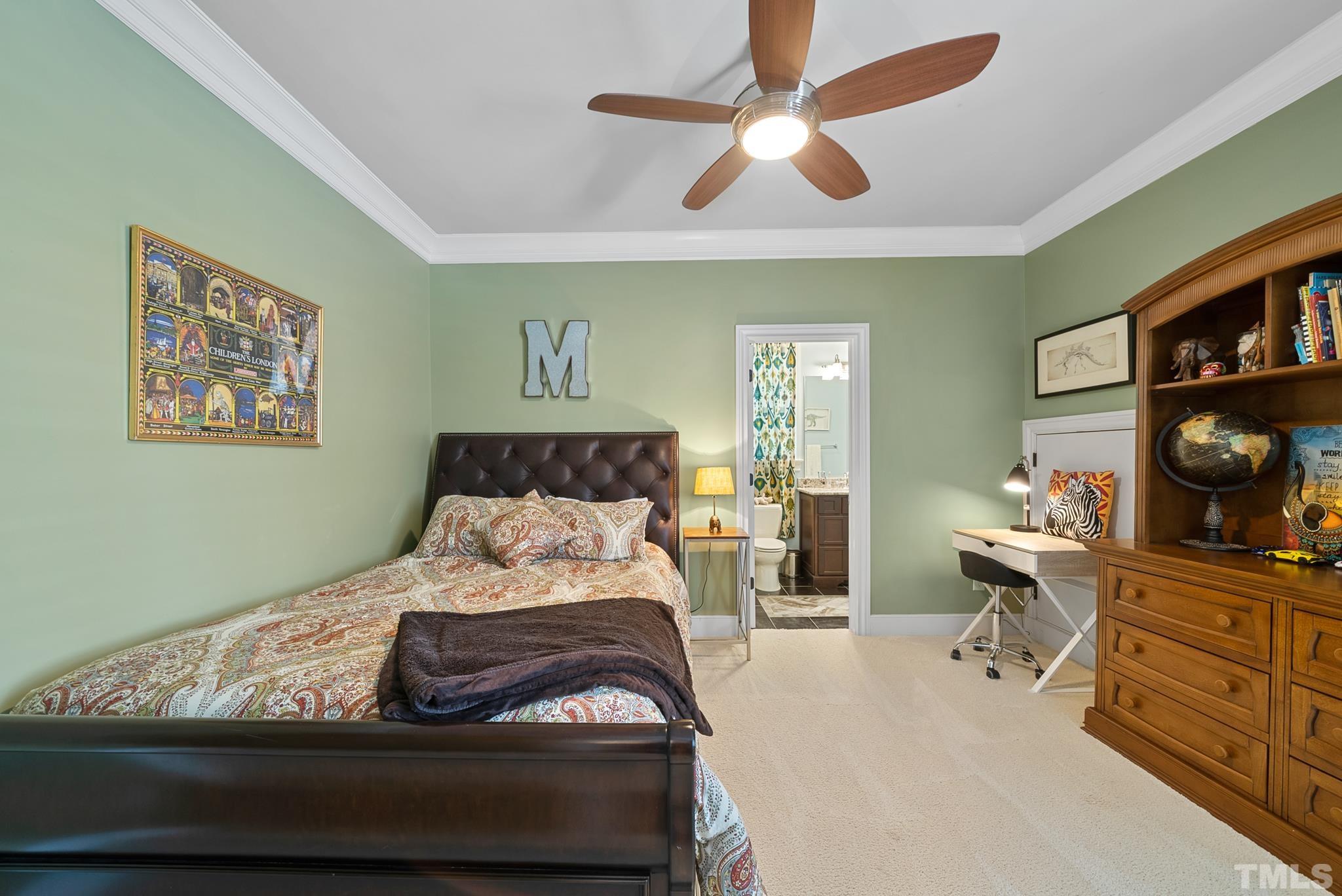 1204 Hedgelawn Way Raleigh, NC 27615 - Photo 26 of 44 a bedroom with a bed and a chandelier