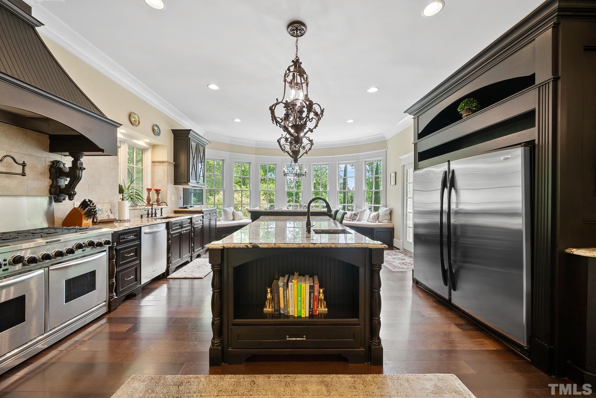 1204 Hedgelawn Way Raleigh, NC 27615 - Photo 7 of 44 a kitchen with stainless steel appliances granite countertop a stove a refrigerator and a stove top oven