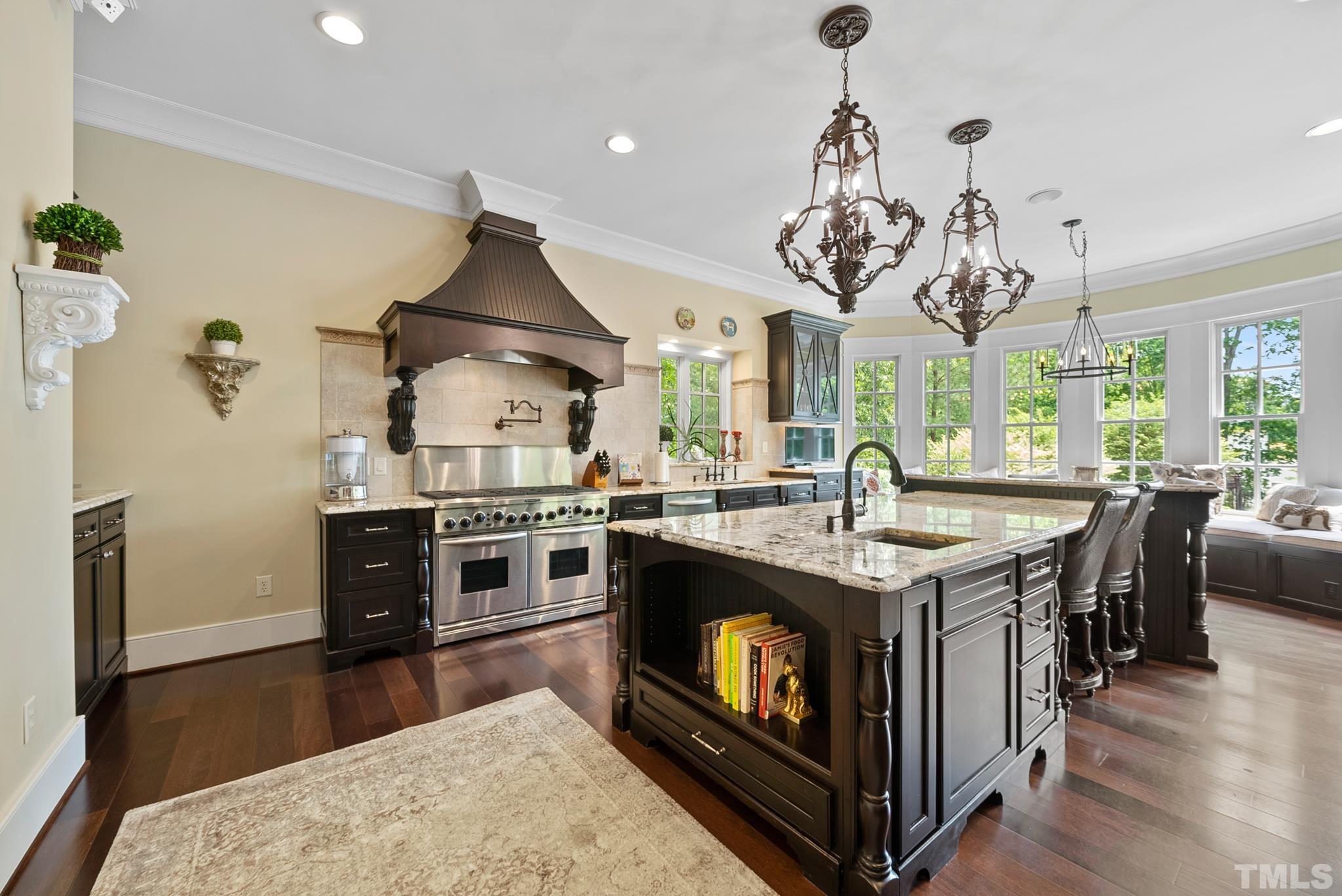 1204 Hedgelawn Way Raleigh, NC 27615 - Photo 8 of 44 a kitchen with stainless steel appliances granite countertop a stove and a refrigerator