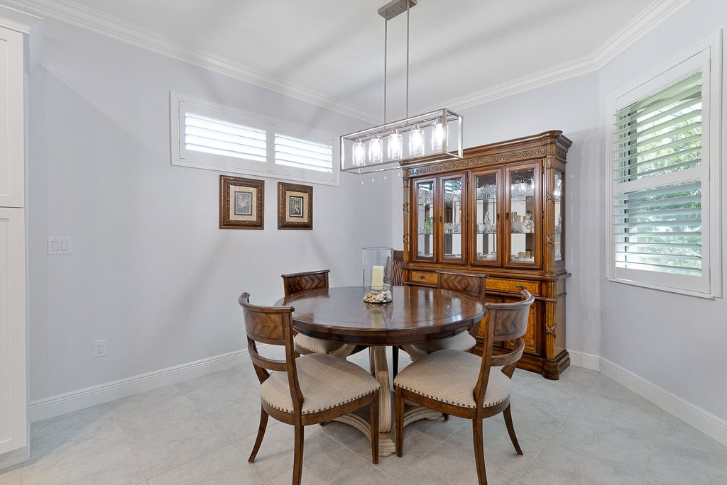 5967 Bella Rosa Lane Vero Beach, FL 32966 - Photo 11 of 30 a dining room with furniture a chandelier and wooden floor