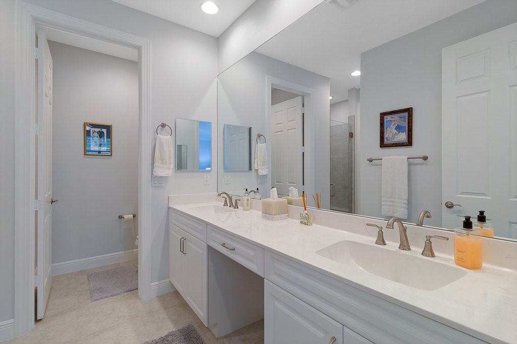 5967 Bella Rosa Lane Vero Beach, FL 32966 - Photo 14 of 30 a bathroom with a double vanity sink mirror and double