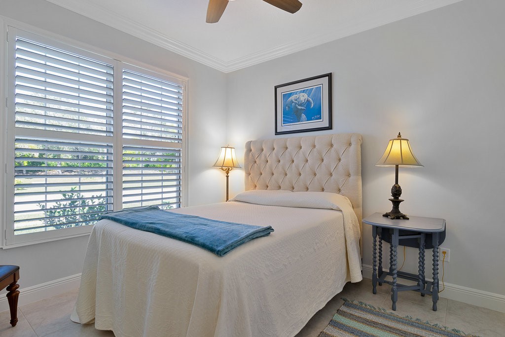5967 Bella Rosa Lane Vero Beach, FL 32966 - Photo 16 of 30 a bedroom with a bed and a lamp next to a window