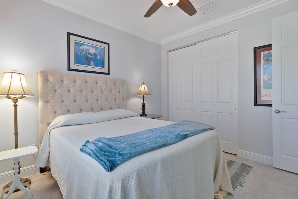 5967 Bella Rosa Lane Vero Beach, FL 32966 - Photo 17 of 30 a bedroom with a bed and a lamp on table