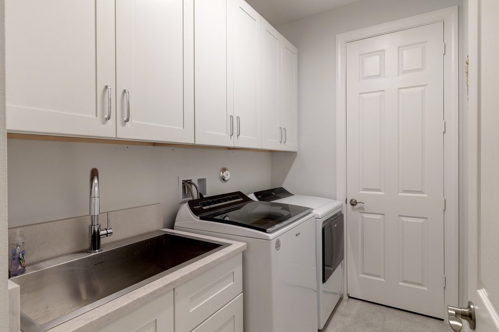 5967 Bella Rosa Lane Vero Beach, FL 32966 - Photo 20 of 30 a kitchen with white cabinets and sink