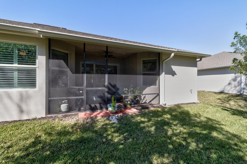 5967 Bella Rosa Lane Vero Beach, FL 32966 - Photo 25 of 30 a front view of a house with a yard