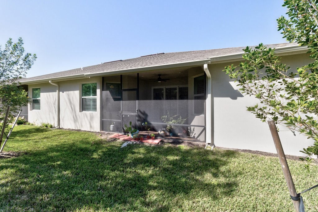 5967 Bella Rosa Lane Vero Beach, FL 32966 - Photo 26 of 30 a view of a house with backyard sitting area and garden