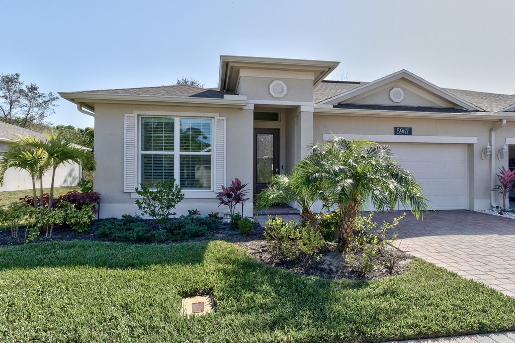 5967 Bella Rosa Lane Vero Beach, FL 32966 - Photo 3 of 30 front view of a house with a yard