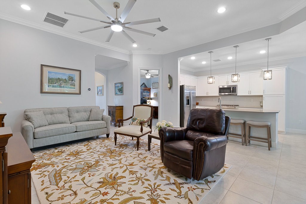 5967 Bella Rosa Lane Vero Beach, FL 32966 - Photo 6 of 30 a living room with furniture and a view of kitchen