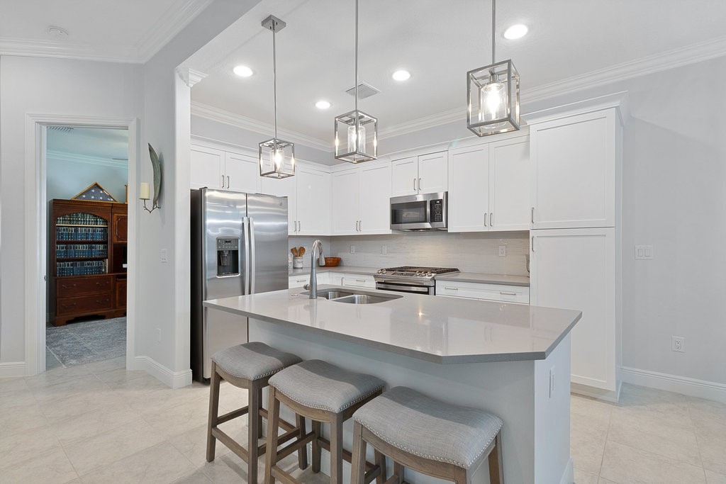 5967 Bella Rosa Lane Vero Beach, FL 32966 - Photo 7 of 30 a large kitchen with a table and chairs