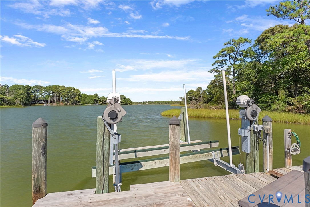 447 Tranquility Road Reedville, VA 22539 - Photo 76 of 82 Private dock with a boat lift, featuring wooden de