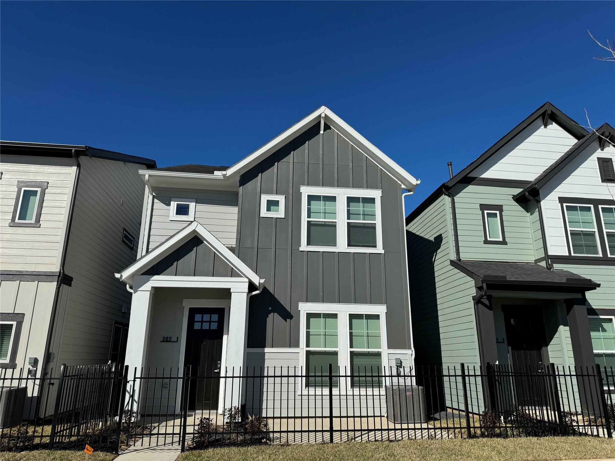 1840 Woodland Field Crossing, Unit 150 Spring, TX 77380 - Photo 1 of 15 a front view of a house with glass windows