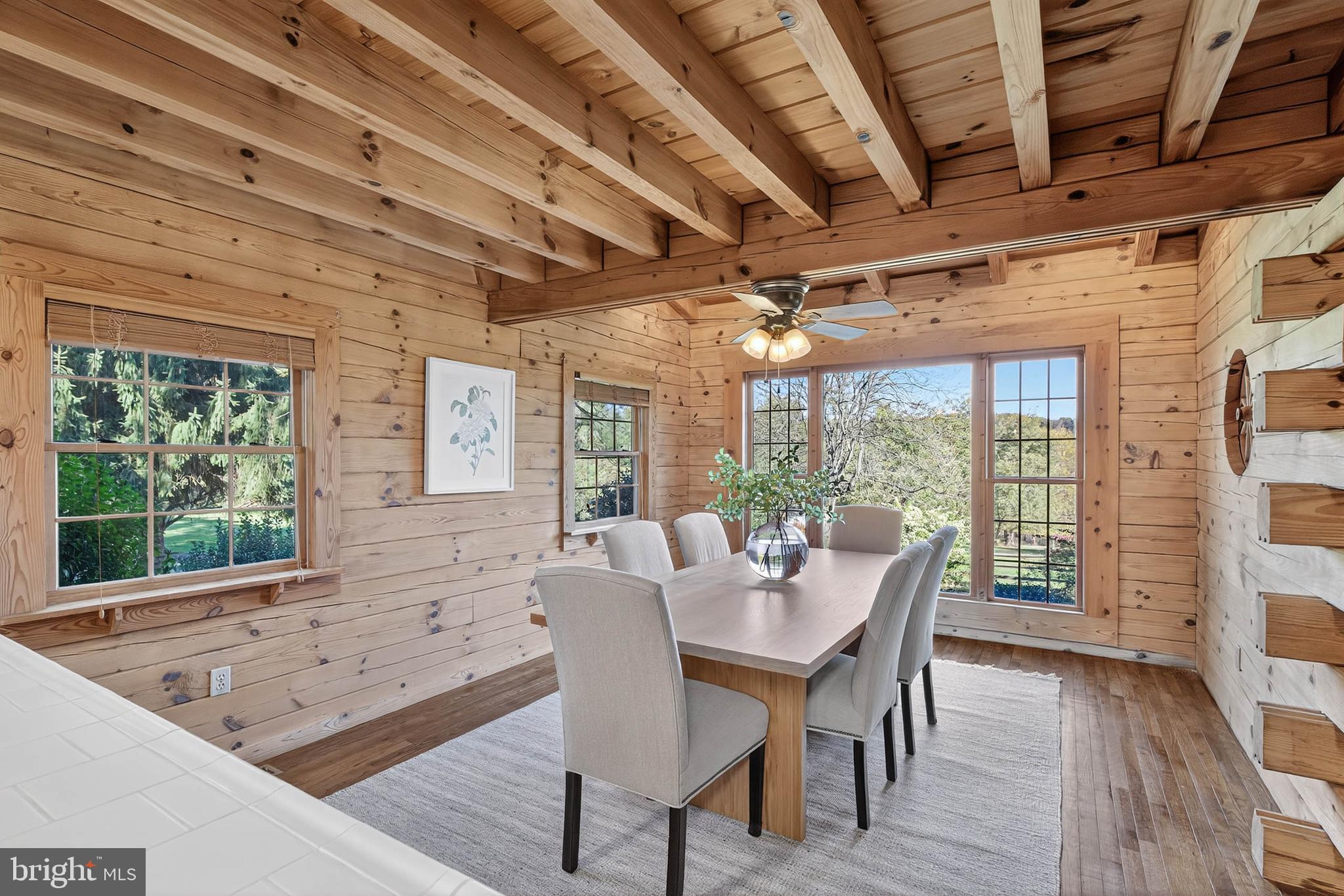 140 Arcadia Trace Peach Bottom, PA 17563 - Photo 19 of 63 a view of a dining room with furniture large windows and wooden floor