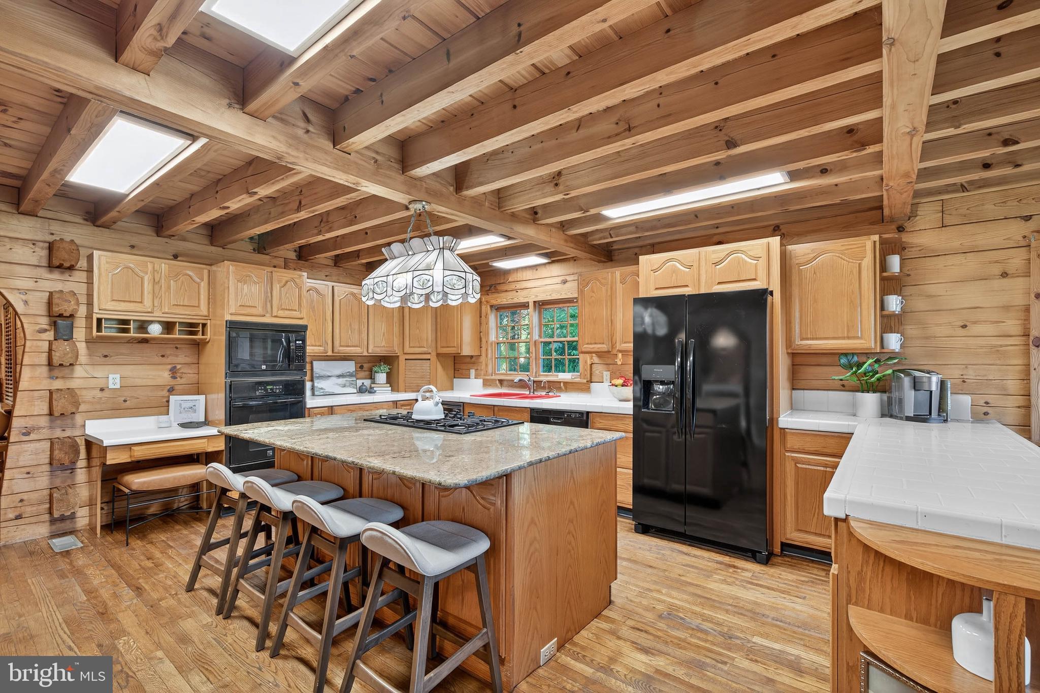 140 Arcadia Trace Peach Bottom, PA 17563 - Photo 22 of 63 a kitchen with stainless steel appliances granite countertop a table chairs and a refrigerator