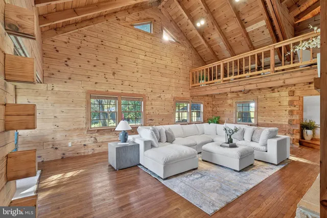 a living room with furniture a fireplace and a table
