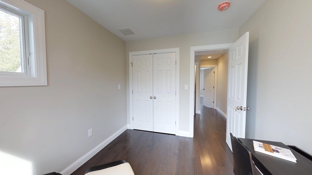 11 Sunset Road, Unit 2 Cambridge, MA 02138 - Photo 18 of 29 an empty room with wooden floor and windows