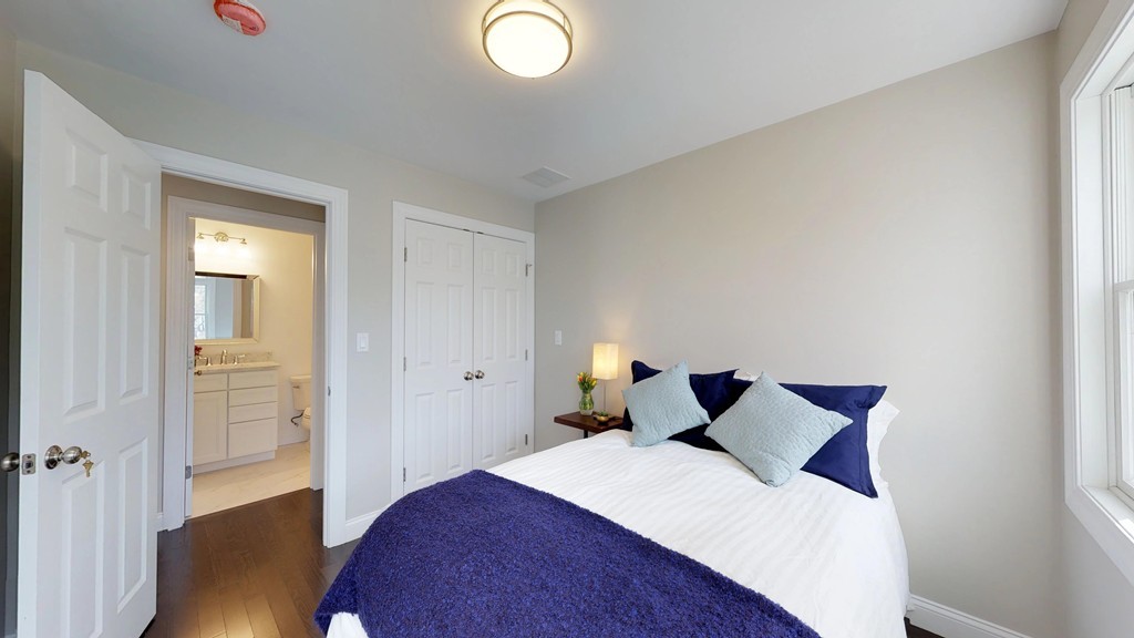 11 Sunset Road, Unit 2 Cambridge, MA 02138 - Photo 21 of 29 a bedroom with a bed and wooden floor