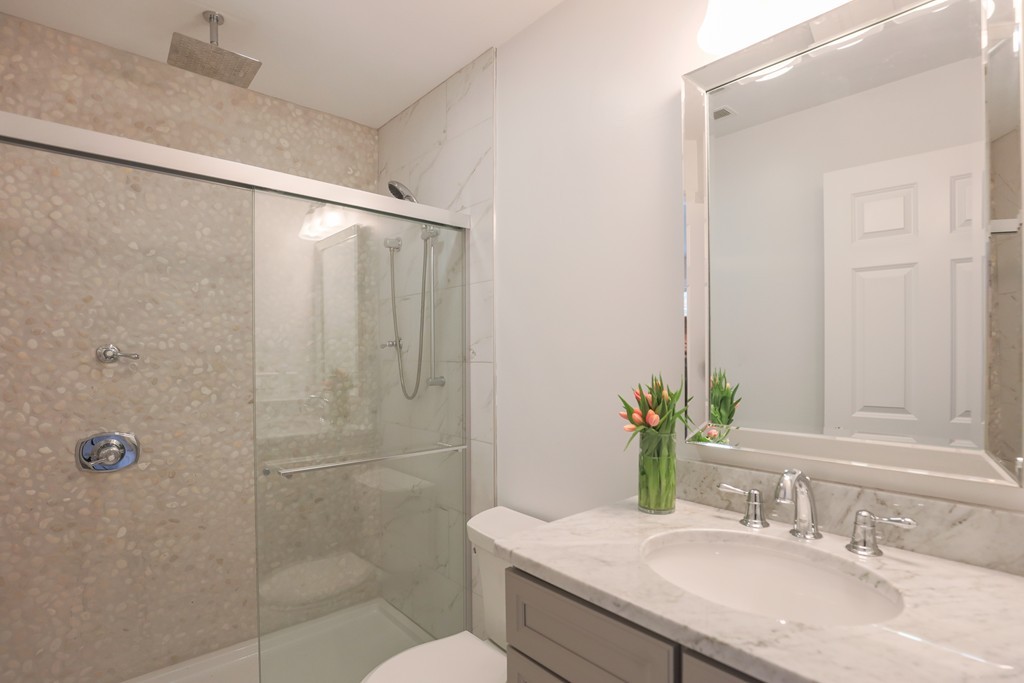 11 Sunset Road, Unit 2 Cambridge, MA 02138 - Photo 25 of 29 a bathroom with a granite countertop sink toilet and shower