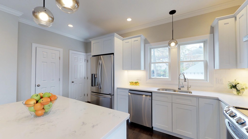 11 Sunset Road, Unit 2 Cambridge, MA 02138 - Photo 4 of 29 a kitchen with a sink a center island cabinets and appliances