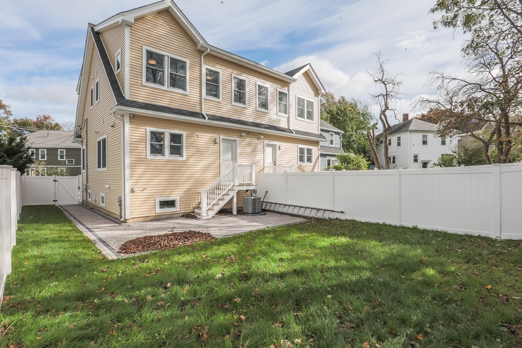 11 Sunset Road, Unit 2 Cambridge, MA 02138 - Photo 6 of 29 a view of a backyard with table and chairs and wooden fence