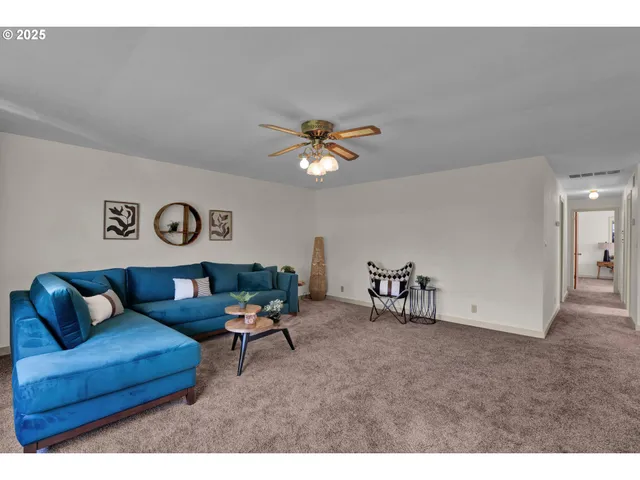 a living room with furniture and a table and a workspace