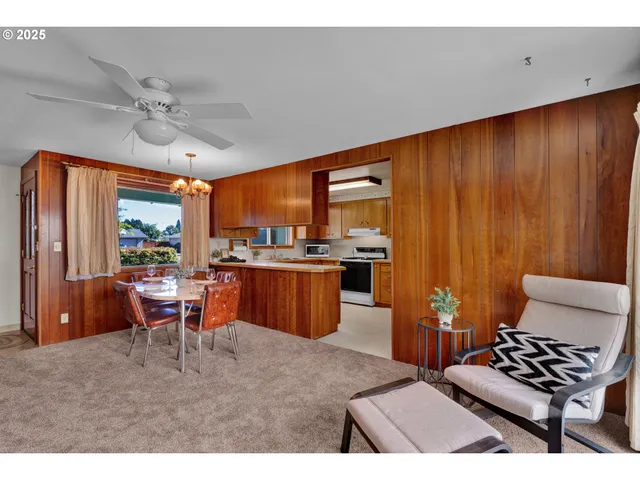 a living room with furniture a ceiling fan and a window