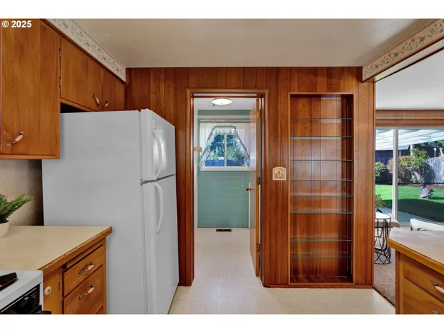a kitchen with stainless steel appliances a refrigerator and a cabinets