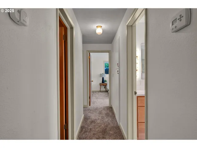 a view of a bathroom from a hallway