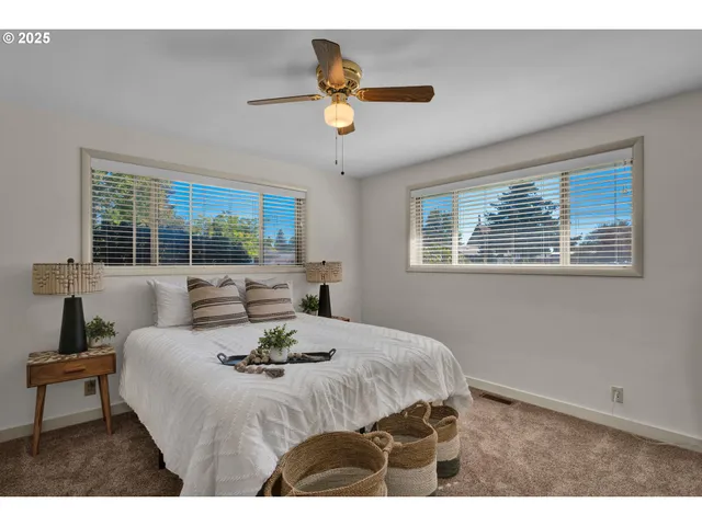 a bed sitting in a bedroom next to a window