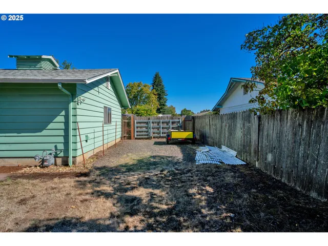 a view of a backyard with plants and a patio