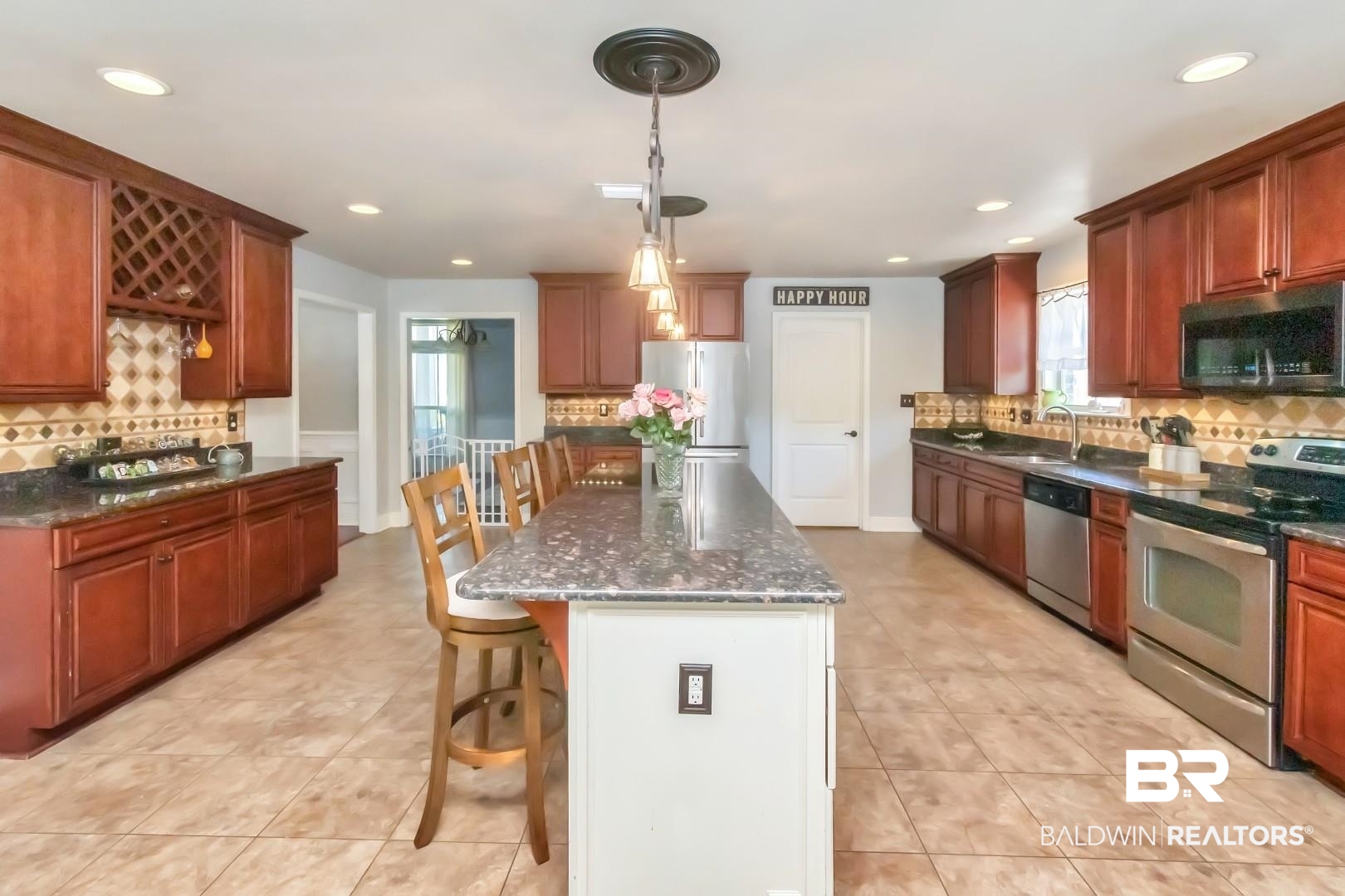 27890 Rileywood Drive Daphne, AL 36526 - Photo 18 of 49 Kitchen with stainless steel appliances, a sink, a kitchen bar, backsplash, and light tile patterned floors