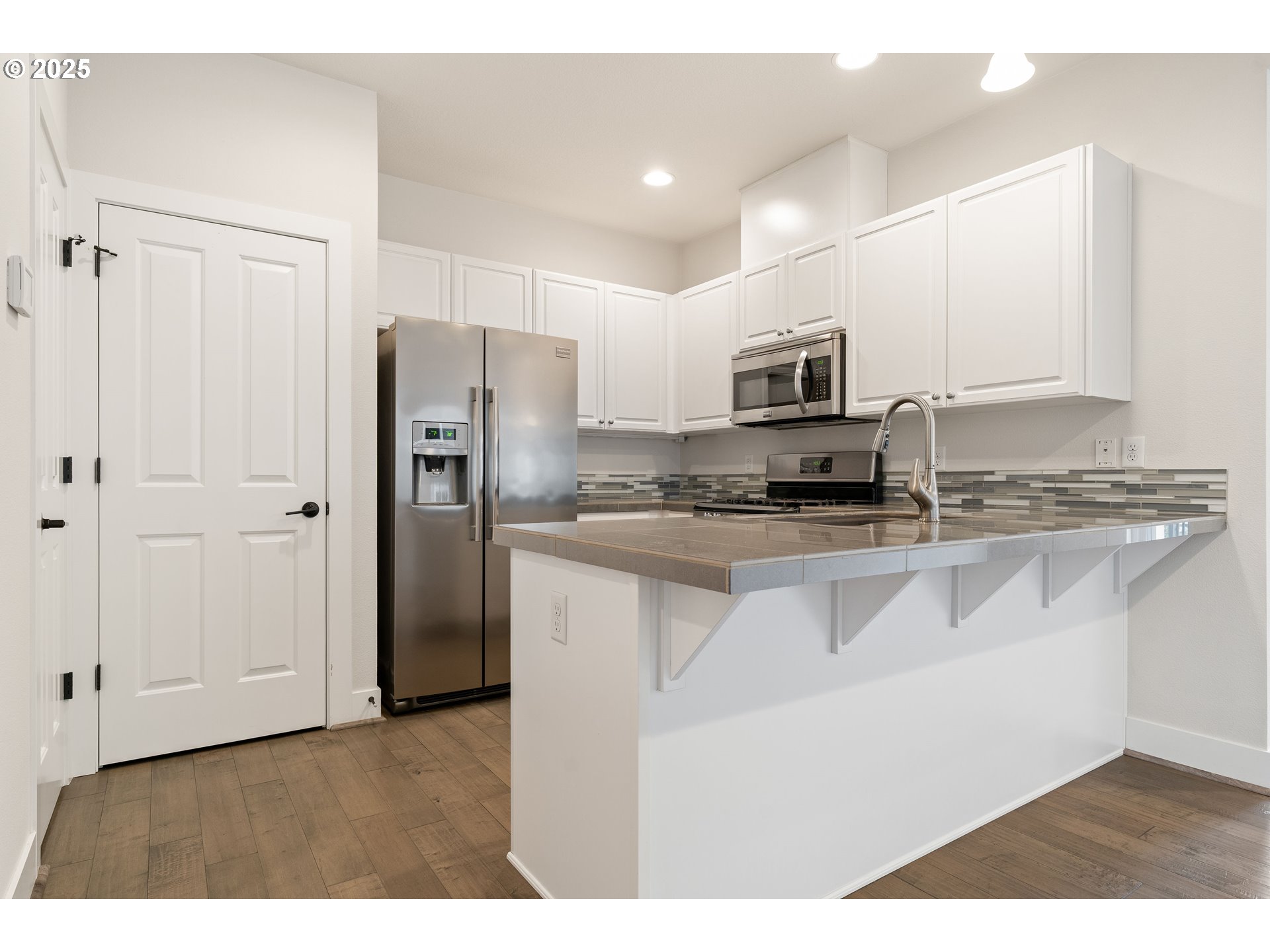 15664 Southwest Ivory Street Beaverton, OR 97007 - Photo 11 of 40 a kitchen with stainless steel appliances granite countertop a refrigerator a stove a sink and a granite counter tops