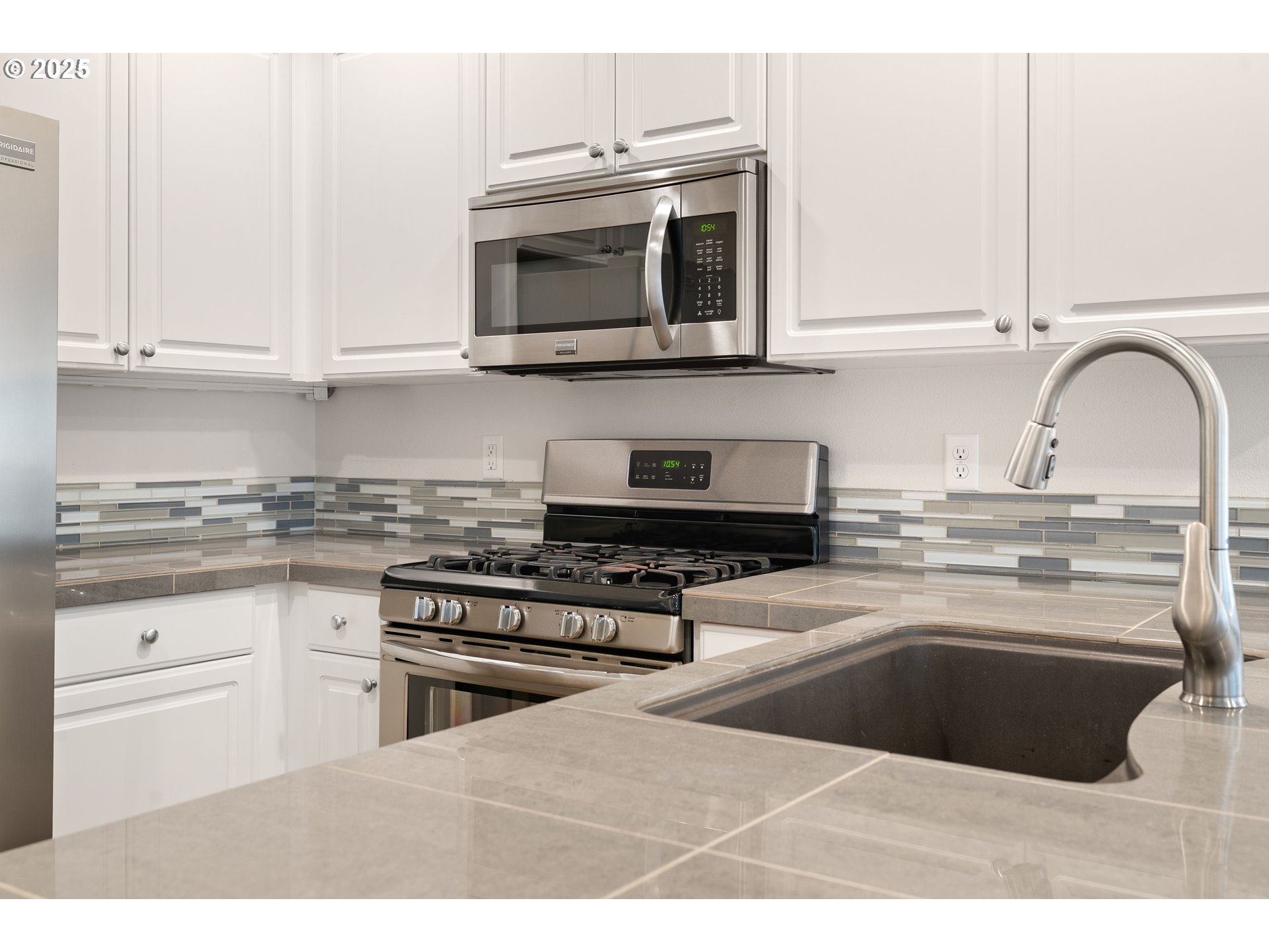 15664 Southwest Ivory Street Beaverton, OR 97007 - Photo 12 of 40 a kitchen with stainless steel appliances granite countertop a sink and cabinets