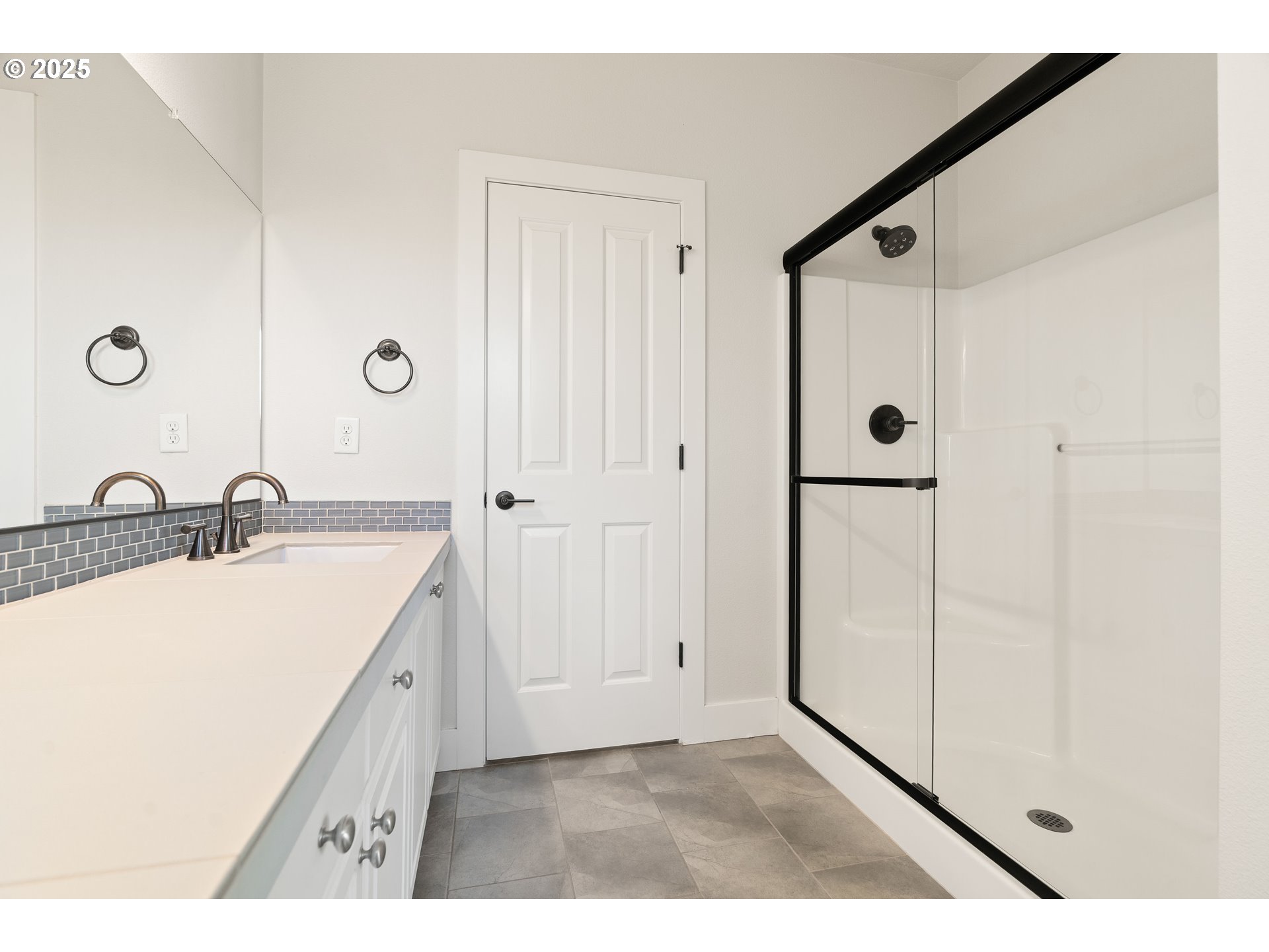 15664 Southwest Ivory Street Beaverton, OR 97007 - Photo 33 of 40 a bathroom with a double vanity sink a mirror and shower