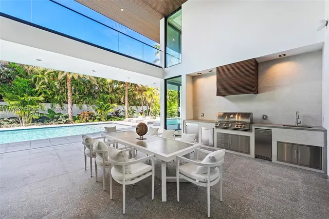 a dining room with furniture and a floor to ceiling window