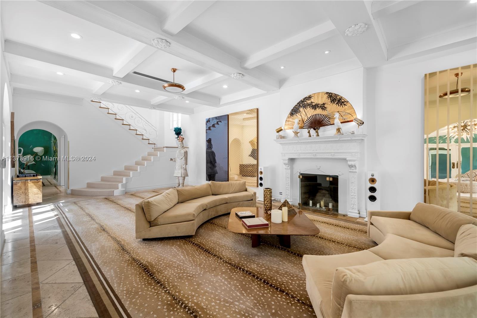 a living room with furniture fireplace and a large window