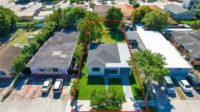 an aerial view of a house with a yard