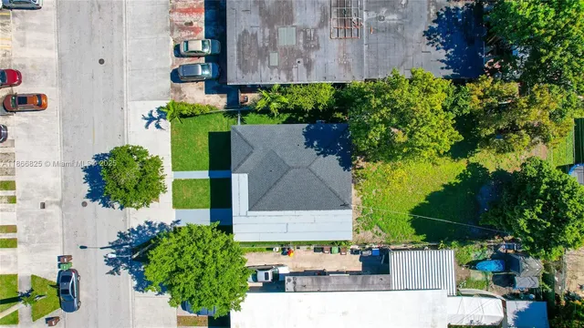 an aerial view of a house with a backyard