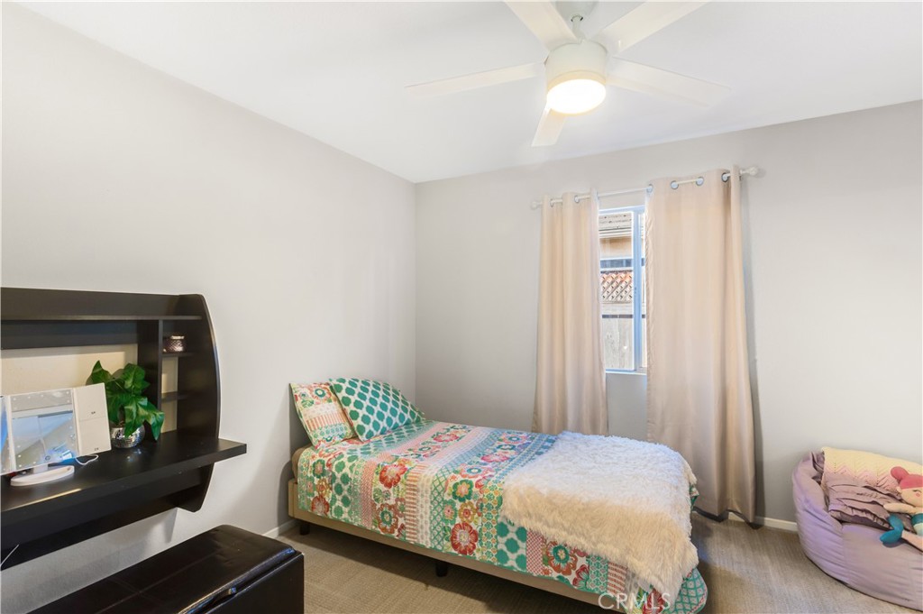 33012 Tulley Ranch Road Temecula, CA 92592 - Photo 14 of 25 a bedroom with a bed window and a couch