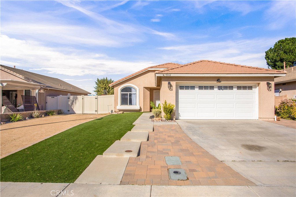 33012 Tulley Ranch Road Temecula, CA 92592 - Photo 2 of 25 a front view of a house with a yard and garage