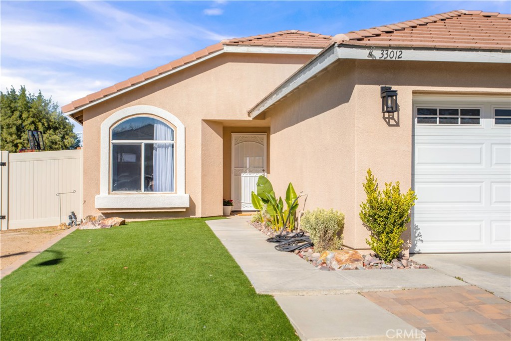 33012 Tulley Ranch Road Temecula, CA 92592 - Photo 3 of 25 a front view of a house with a garden