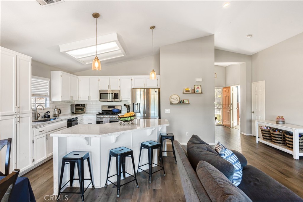 33012 Tulley Ranch Road Temecula, CA 92592 - Photo 6 of 25 a large kitchen with a table and chairs