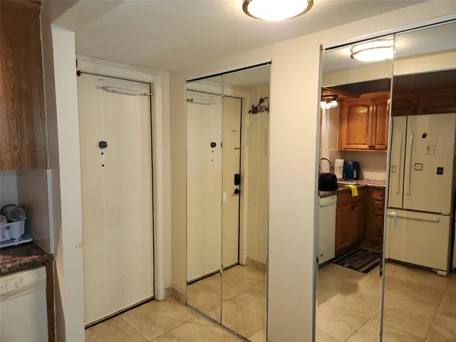 a view of a walk in closet and a bathroom