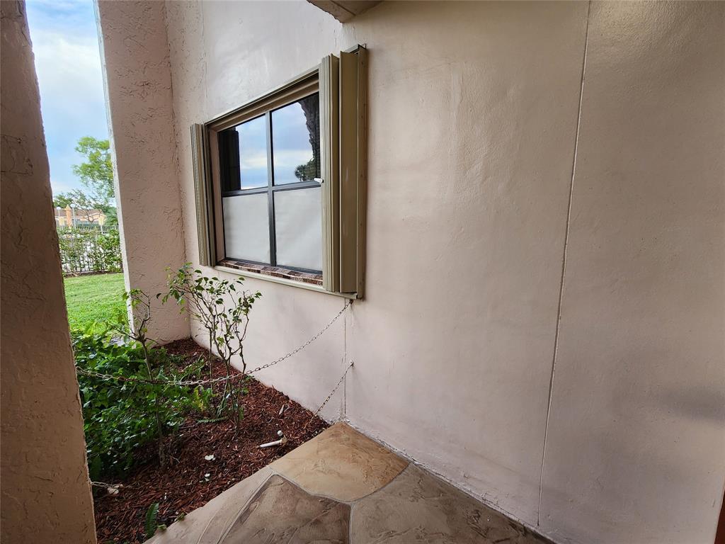 10180 Northwest 30th Court, Unit 101 Sunrise, FL 33322 - Photo 14 of 21 a view of a door and a window
