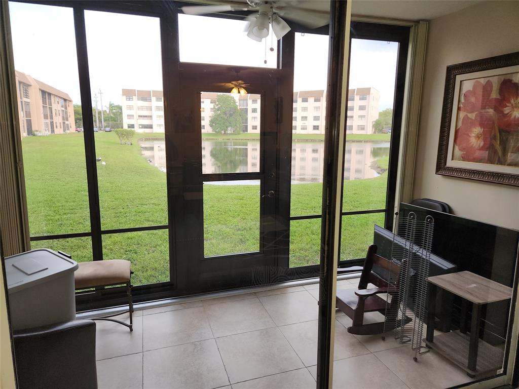 10180 Northwest 30th Court, Unit 101 Sunrise, FL 33322 - Photo 2 of 21 a living room filled with furniture