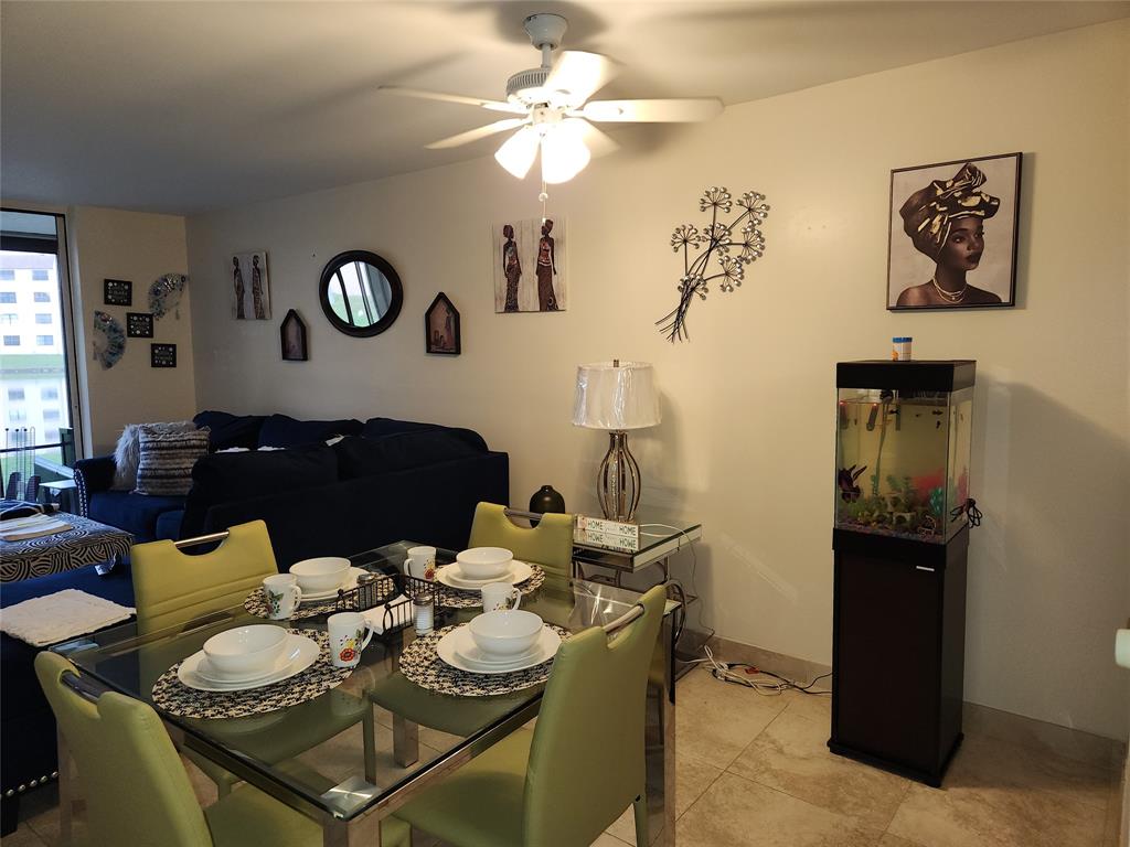 10180 Northwest 30th Court, Unit 101 Sunrise, FL 33322 - Photo 3 of 21 a dining room with furniture and a chandelier fan