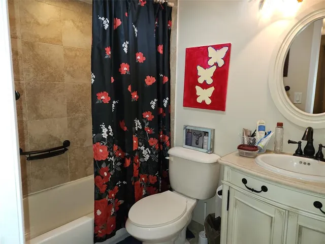 a bathroom with a toilet a sink and a mirror