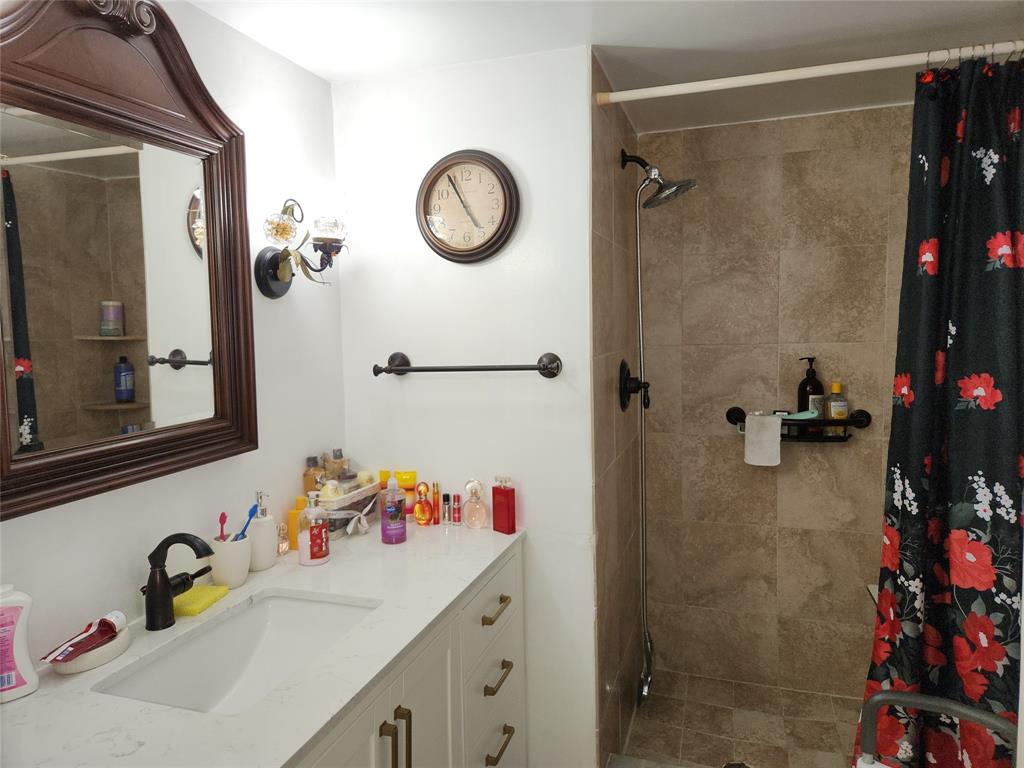 10180 Northwest 30th Court, Unit 101 Sunrise, FL 33322 - Photo 7 of 21 a bathroom with a sink and a mirror