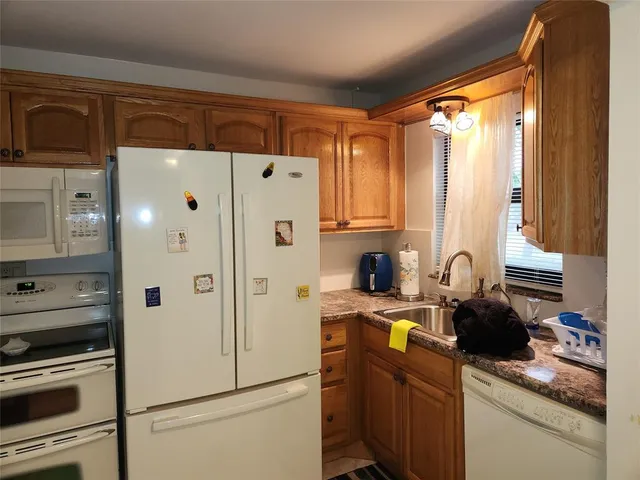 a white refrigerator freezer sitting in a kitchen