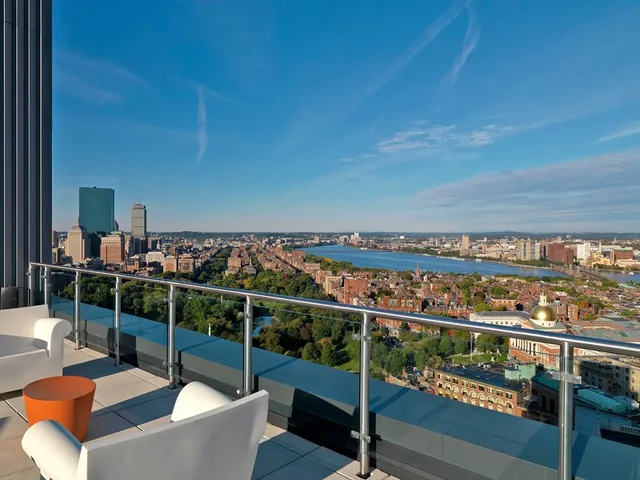 a view of a chairs and table in the balcony