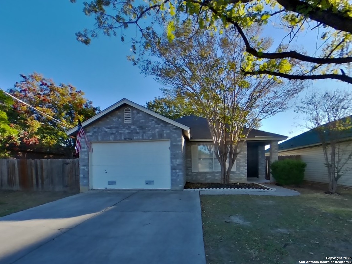 a view of a house with a tree and yard